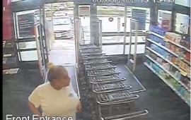 Woman walking into Walgreens wanted for questioning in a theft. Wearing a white t shirt hair up in a bun