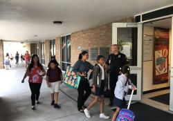 School Resource Officer Ashby welcomes students on the first day of school at Tommie Barfield Elementary